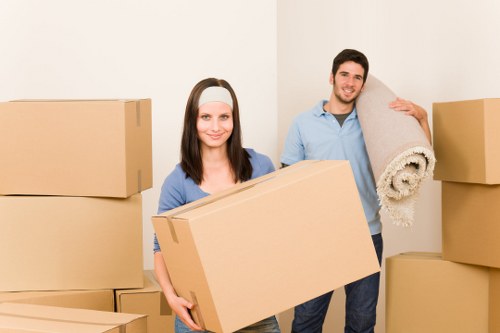 Professional movers carrying furniture through a Tulse Hill home