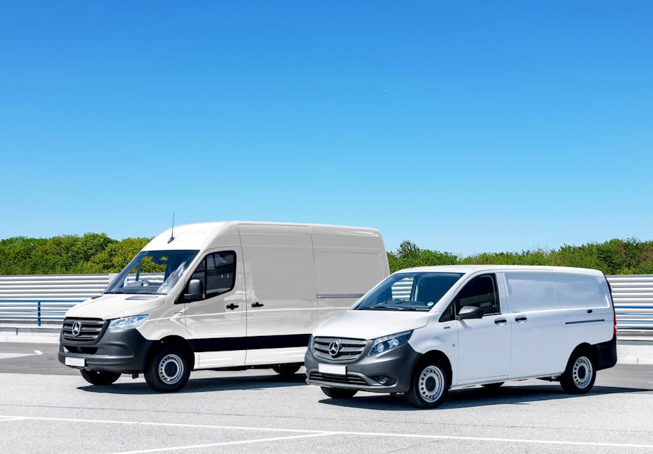 Two white Mercedes-Benz panel vans parked side by side on a paved road with clear blue sky and green trees in the background, showcasing different sizes of cargo vehicles used in house removals and fu